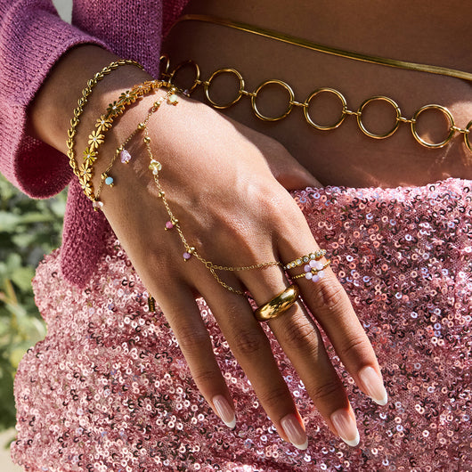 Gold-colored bracelet with a chain of small, interconnected heart-shaped links, featuring a lobster clasp and extender.