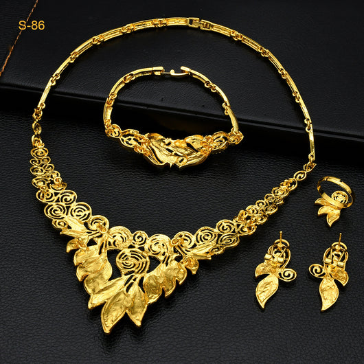 Women's Saudi bridal four-piece gold-colored jewelry set with floral and leaf designs, featuring a necklace, bracelet, earrings, and ring. - Image 4