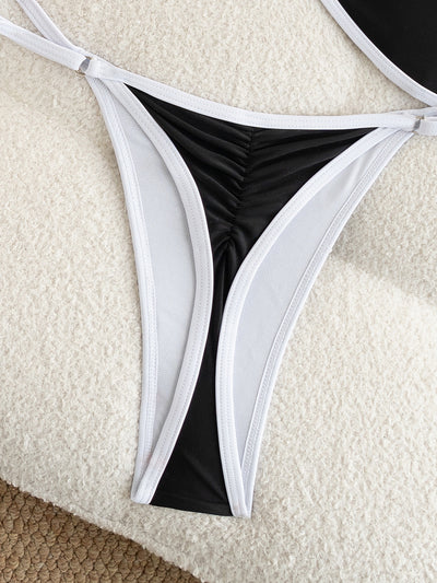 Black and white strapless bikini swimsuit set with adjustable straps and a ruched bottom, laid flat. - Image 15