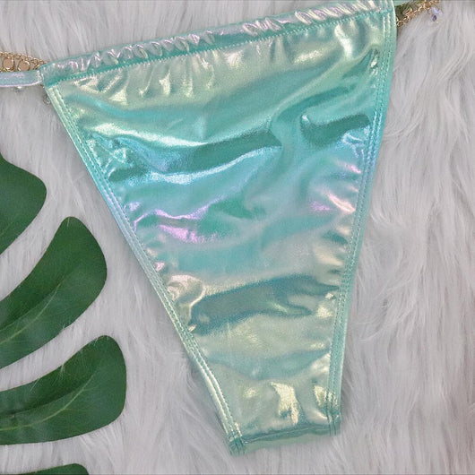 Iridescent purple and pink two-piece bikini with gold-toned crystal embellishments on a white faux fur background. - Image 24