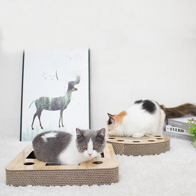 Round corrugated cardboard cat scratcher with a central scratching pad and multiple holes containing colorful balls. - Image 4