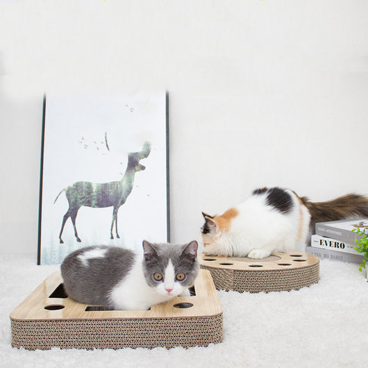 Round corrugated cardboard cat scratcher with a central scratching pad and multiple holes containing colorful balls. - Image 4