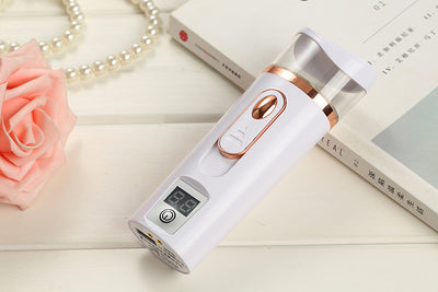 White and rose gold nano spray water meter with a clear tank, digital display, and power button. - Image 17