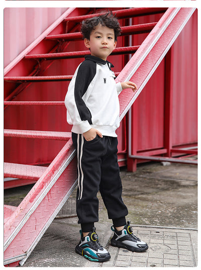 Black, white, and neon green children's basketball shoes with rotating buckle closure, featuring a mid-top design. - Image 15