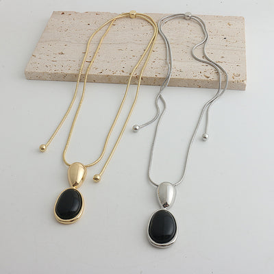 Pair of gold-toned irregular earrings with black onyx-like inserts, featuring a modern, abstract design. - Image 18