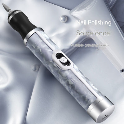Silver-gray portable nail polishing instrument with a sleek, pen-like design and textured body.