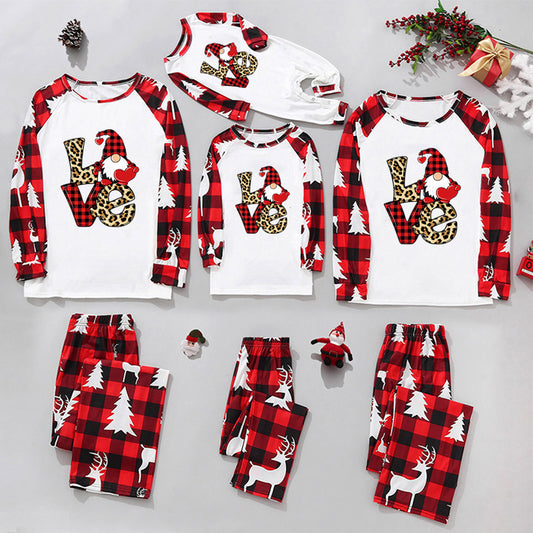 Matching family Christmas pajamas with red and black plaid, white trees, reindeer, and 'LOVE' with a gnome and leopard print.