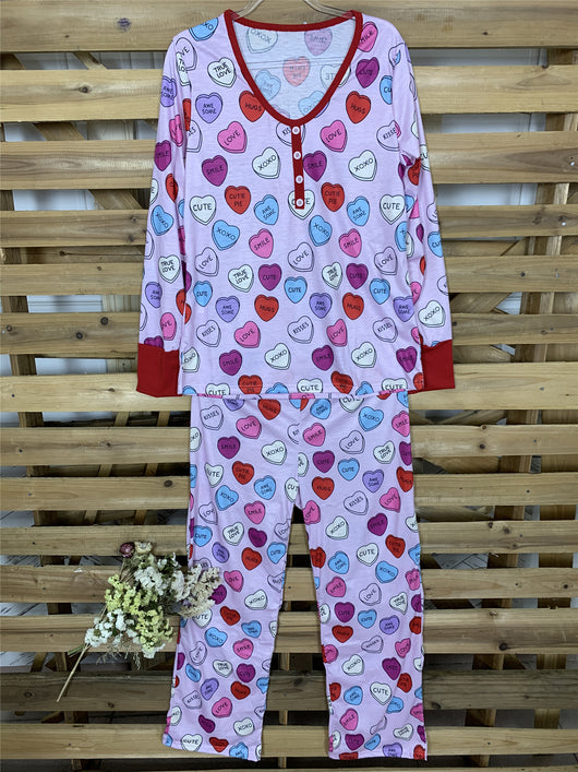 Pink long-sleeve pajama set with a conversation heart print, red Henley neckline, and matching full-length pants. - Image 17