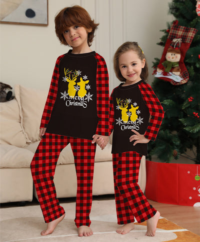 Two children in matching black and red buffalo plaid Christmas pajamas with golden deer and "Merry Christmas" print. - Image 13