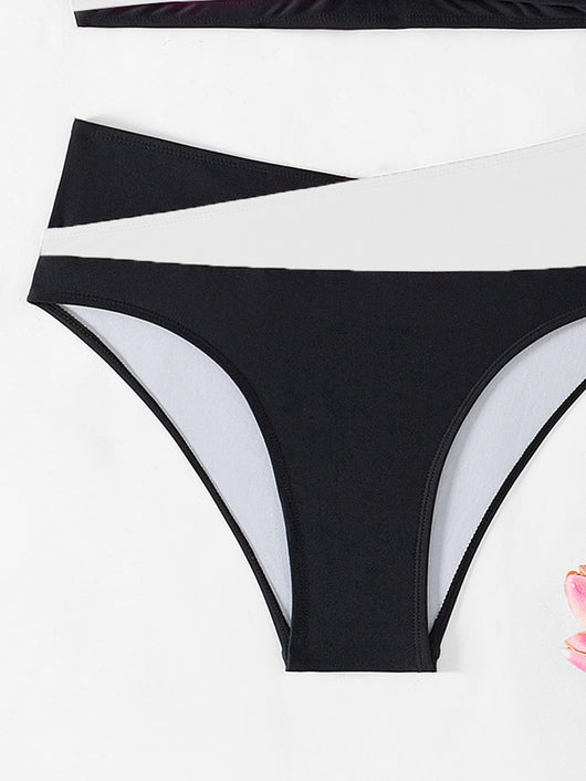 Black and white color-block halter bikini with high-waisted bottoms, modeled by a woman holding a straw hat. - Image 25
