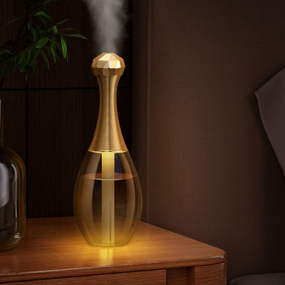 Mini silent portable humidifier shaped like a perfume bottle, with a clear body and a gold ribbed neck and faceted cap. - Image 11