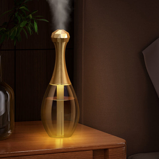 Mini silent portable humidifier shaped like a perfume bottle, with a clear body and a gold ribbed neck and faceted cap. - Image 11