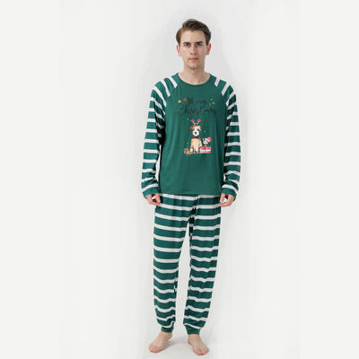Woman in a Christmas pajama set with a white top, green sleeves, dinosaur graphic, and green fair isle pants. - Image 6