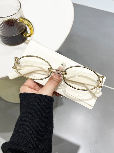 Retro small frame sunglasses with gold round frames and leopard print temples, held by a hand. - Image 15