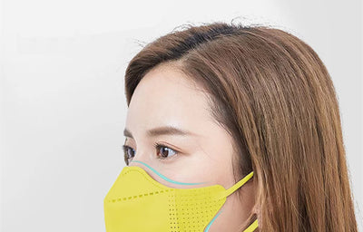 Peach disposable 3-layer face mask with perforated details worn by a person, offering comfortable daily protection. - Image 33