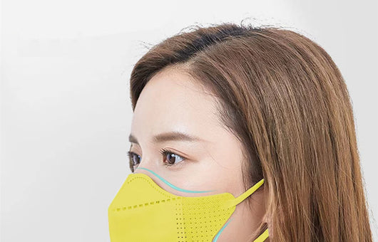 Peach disposable 3-layer face mask with perforated details worn by a person, offering comfortable daily protection. - Image 33
