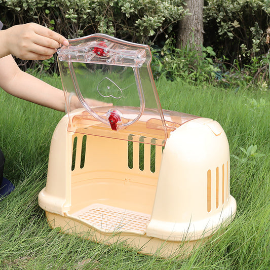 Brown pet carrier with a clear front door, top handle, ventilation slots, and a white urinating pad. - Image 2
