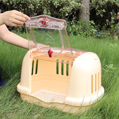 Brown pet carrier with a clear front door, top handle, ventilation slots, and a white urinating pad. - Image 2