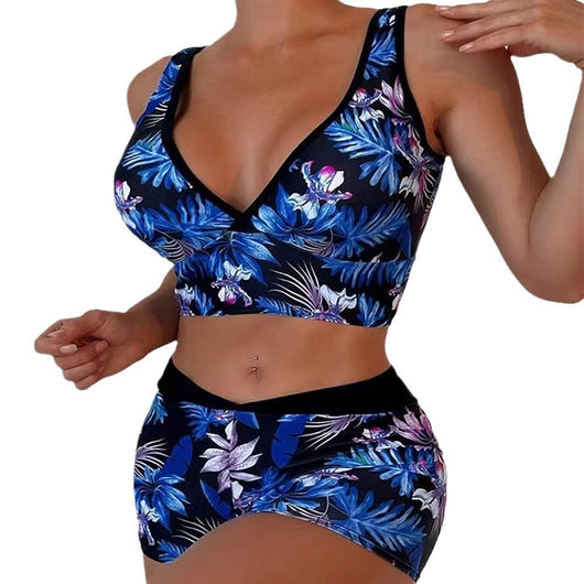 Two-piece swimsuit with a black background and vibrant pink and purple tropical floral print. Features a V-neck crop top and high-waisted boxer shorts. - Image 5