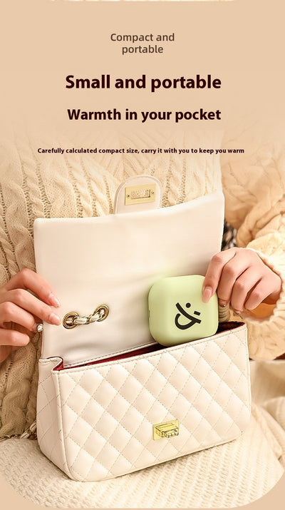 Light green square hand warmer with rounded corners and a black smiley face, hanging from a two-tone lanyard. - Image 10