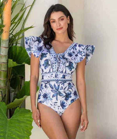 Women's blue and white floral one-piece swimsuit with ruffled V-neck and matching sarong skirt with bow. - Image 29