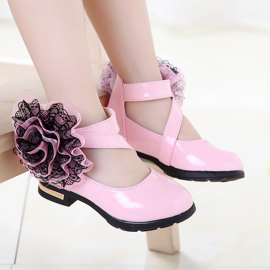 Shiny red princess shoes for little girls with a T-strap, Velcro closure, and a large red and black lace flower. - Image 6