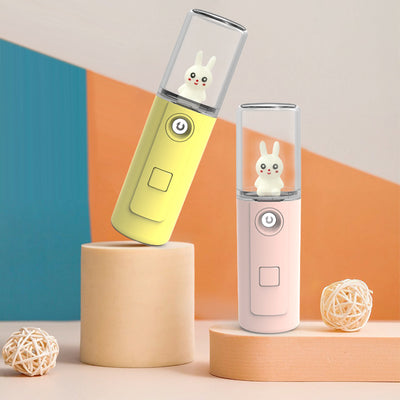 Green portable facial mister with a clear top and a white cartoon rabbit figure inside, featuring a power button. - Image 8
