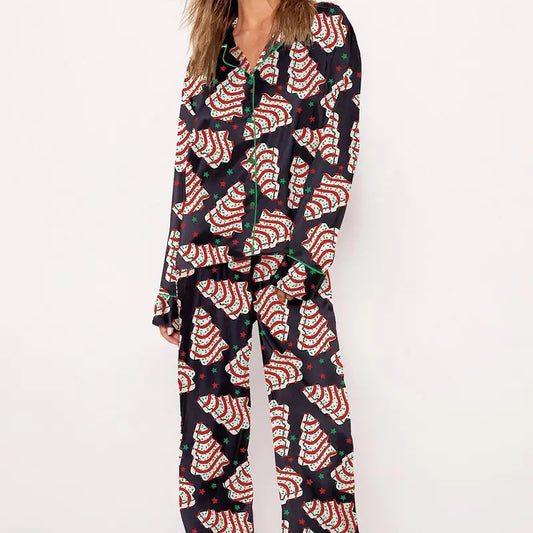 White short-sleeve pajama set with red and green Christmas tree and star print, featuring green piping.