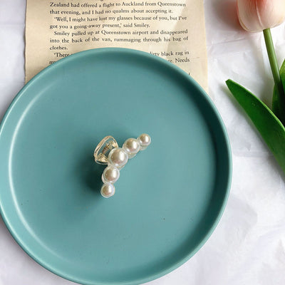 Clear plastic hair claw clip adorned with a single row of white faux pearls and a gold-toned spring. - Image 11