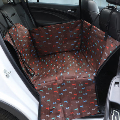 Brown pet car mat with colorful dog pattern installed in a car's rear seat, protecting upholstery. - Image 13