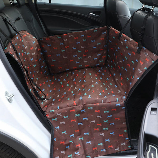 Brown pet car mat with colorful dog pattern installed in a car's rear seat, protecting upholstery. - Image 13