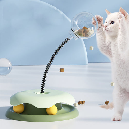 Mint green and dark green cat leakage food toy with a clear spherical treat dispenser on a black spring. - Image 2