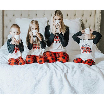 Family of three wearing matching Christmas pajamas with white tops, black raglan sleeves, and red buffalo plaid bear graphics, paired with red and black buffalo - Image 4
