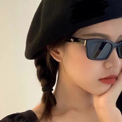 Transparent gray frame sunglasses with dark gray rectangular lenses and small gold accents on the temples. - Image 12