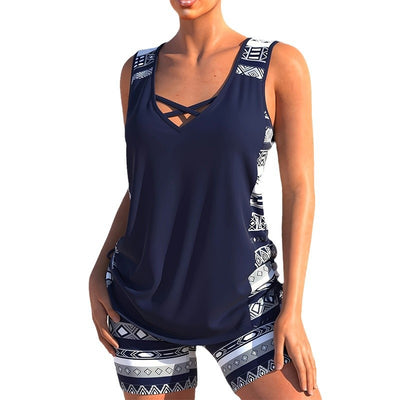 Women's navy blue tankini swimsuit with geometric pattern, criss-cross V-neck, and matching swim shorts. - Image 17