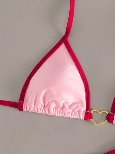 Pink and red halter-style triangle bikini with heart-shaped hardware and tie-up thong bottom, worn on a beach. - Image 18