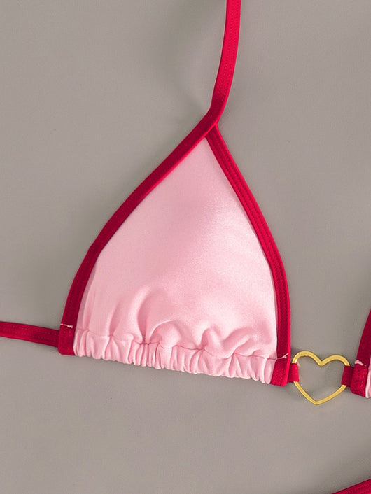 Pink and red halter-style triangle bikini with heart-shaped hardware and tie-up thong bottom, worn on a beach. - Image 18