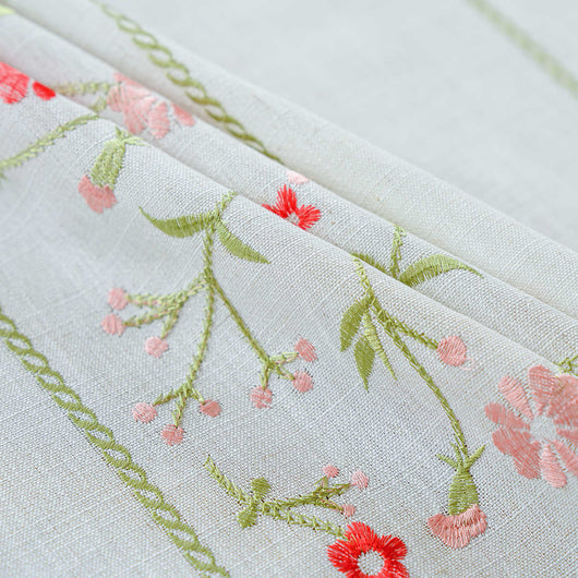 White semi-sheer curtain with brown botanical embroidery and white tassels, draped over a small wooden table. - Image 4