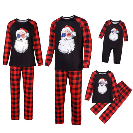 Christmas pajama set with a black long-sleeve top featuring a Santa head in American flag sunglasses and red and black buffalo plaid pants.