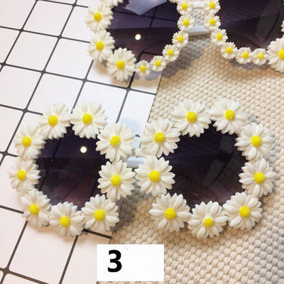 White round sunglasses with daisy flower embellishments on the frames and dark gradient lenses. - Image 2