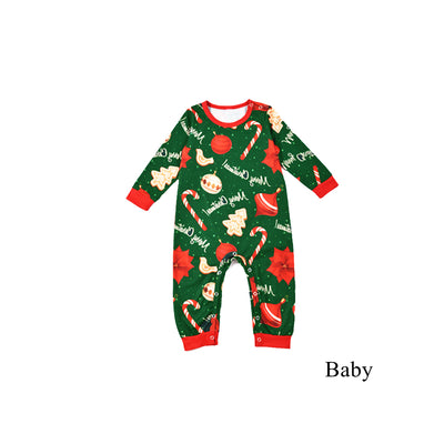 Green baby Christmas pajama romper with red trim, featuring candy canes, ornaments, gingerbread men, and poinsettias. - Image 4