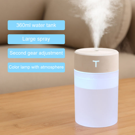 White and clear cylindrical mini humidifier with a 'T' logo, featuring a top mist outlet and transparent water tank. - Image 3