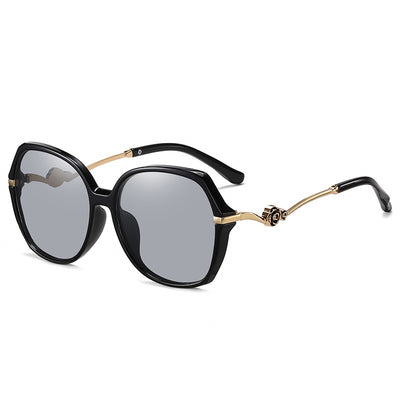 Oversized round-frame sunglasses with pink polarized lenses, translucent pink and brown frame, and gold floral temple accents. - Image 5