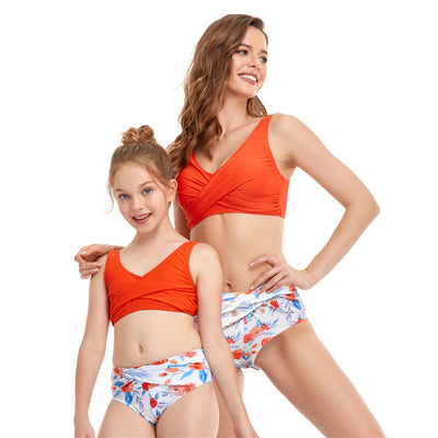 Mother and daughter in matching black V-neck bikini tops and high-waisted orange paisley print bottoms. - Image 14