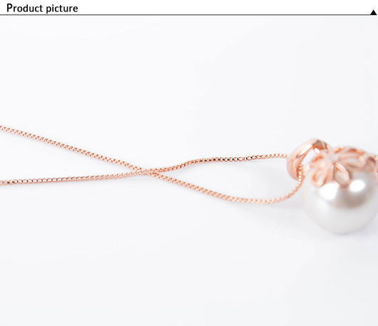Rose gold-toned necklace and drop earrings set with white spherical pearls and clear rhinestone accents. - Image 7