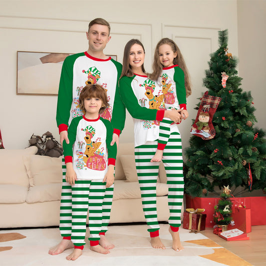 Woman wearing green and white striped holiday pajamas with a Scooby-Doo "Happy Holidays!" graphic on the top.