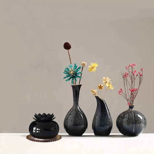 Black spherical aromatherapy humidifier with a lotus flower top, emitting mist, sitting on a gold decorative doily. - Image 7