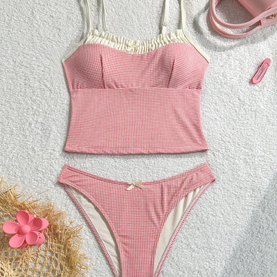 Gingham two-piece swimsuit with a camisole top featuring ruffled trim and a bow, paired with high-cut bikini bottoms.