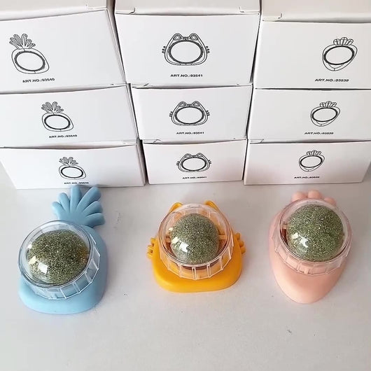 Orange carrot-shaped cat toy with a clear dome holding a rotating catnip ball, next to its white packaging box. - Image 25