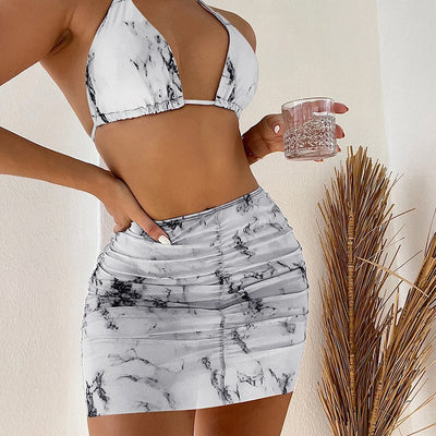 White and black marble print three-piece bikini set with a halter top and ruched mini skirt. - Image 9